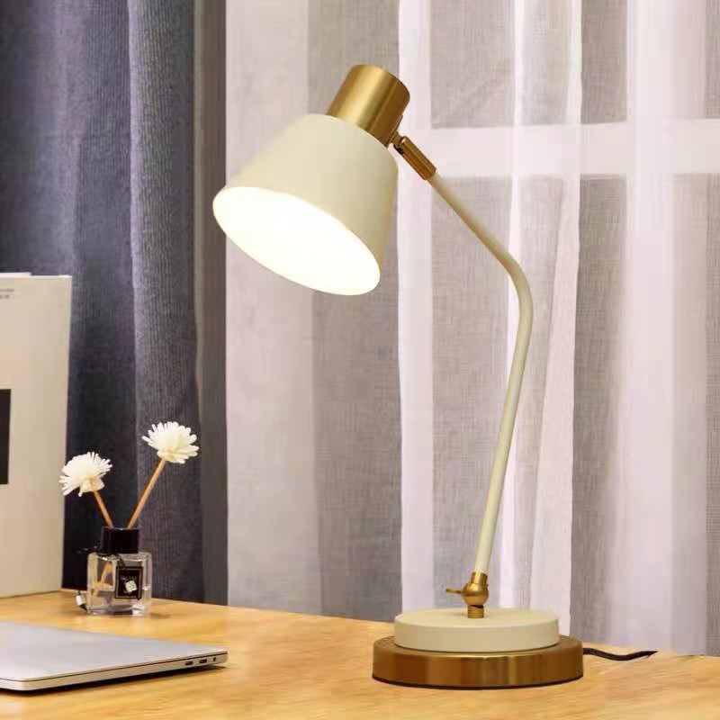 Adjustable metal desk lamp with swivel arm and brass accents