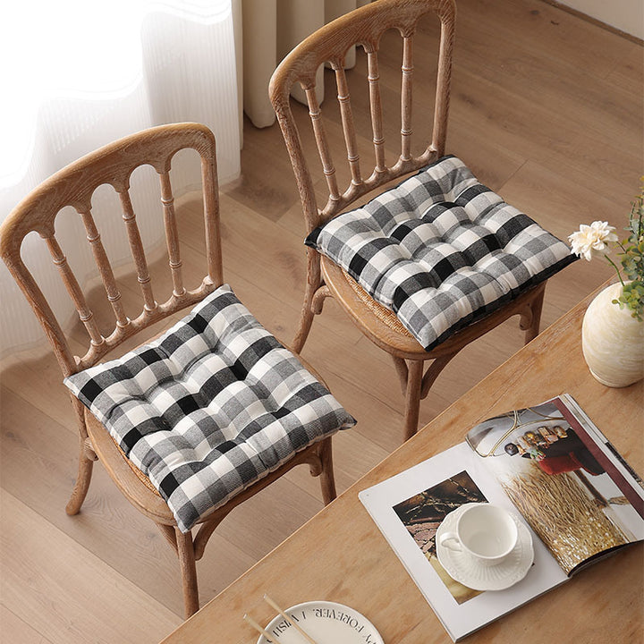 Padded quilted seat cushion with colorful button applications and non-slip underside