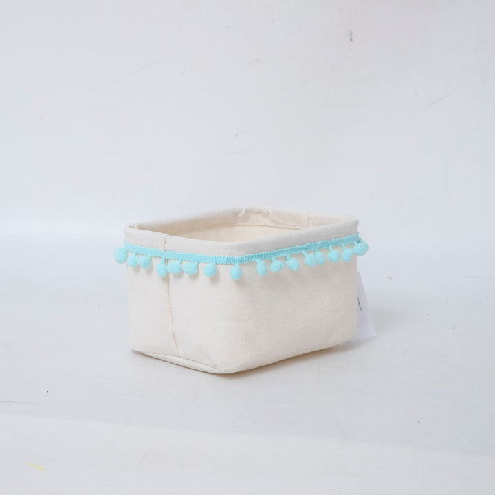 Storage basket with decorative pom-pom trim
