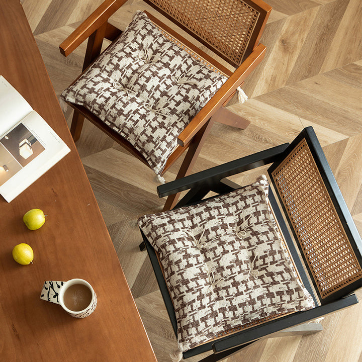 Decorative woven seat cushion with tufting and tassels