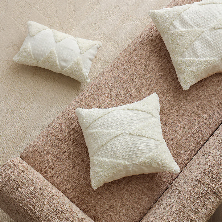Square decorative pillow with tufted triangle structure and bouclé surface