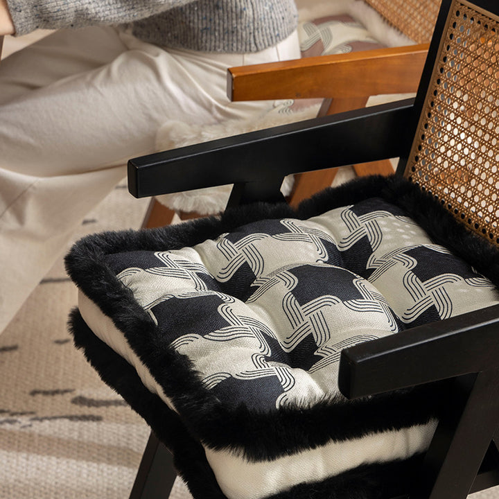 Padded seat cushion with fastening straps, quilted tufting surface and faux fur trim