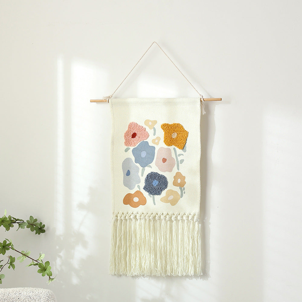 Woven cotton wall hanging with punch needle flower relief and fringes