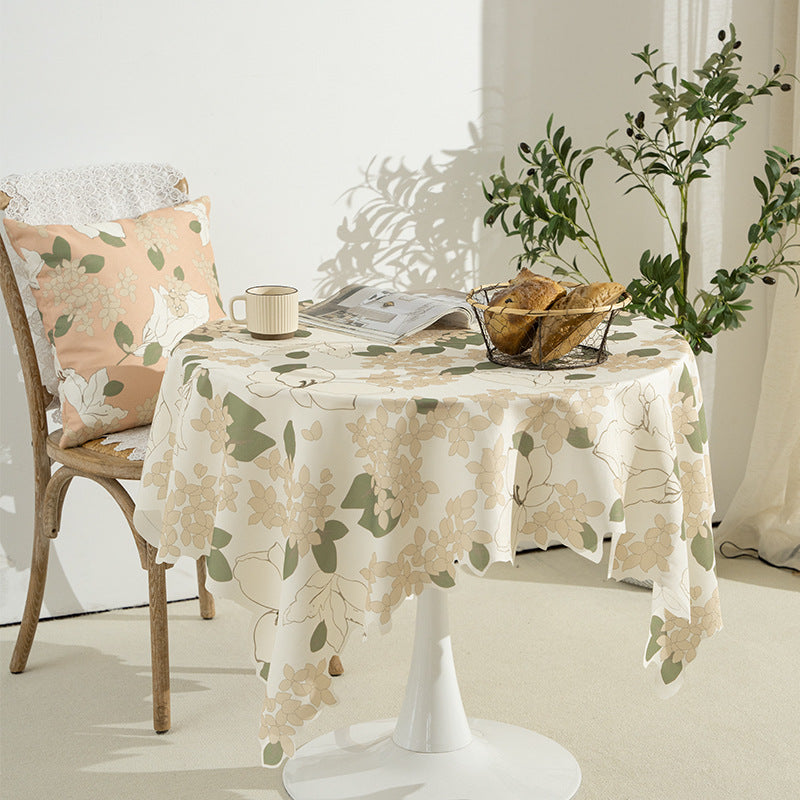 Round wipeable tablecloth with floral cut-out hem