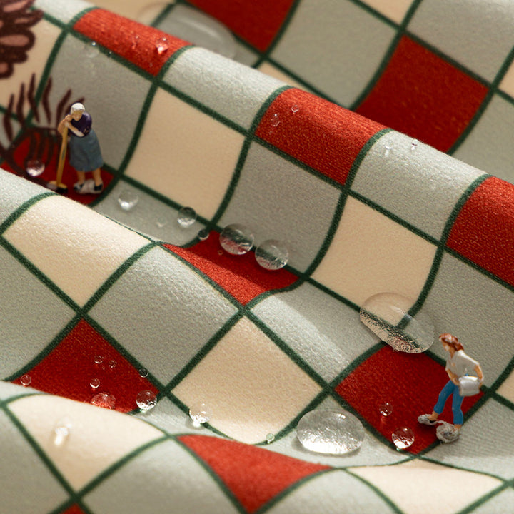 Checked flannel tablecloth with pom-pom tassels and traditional tartan pattern