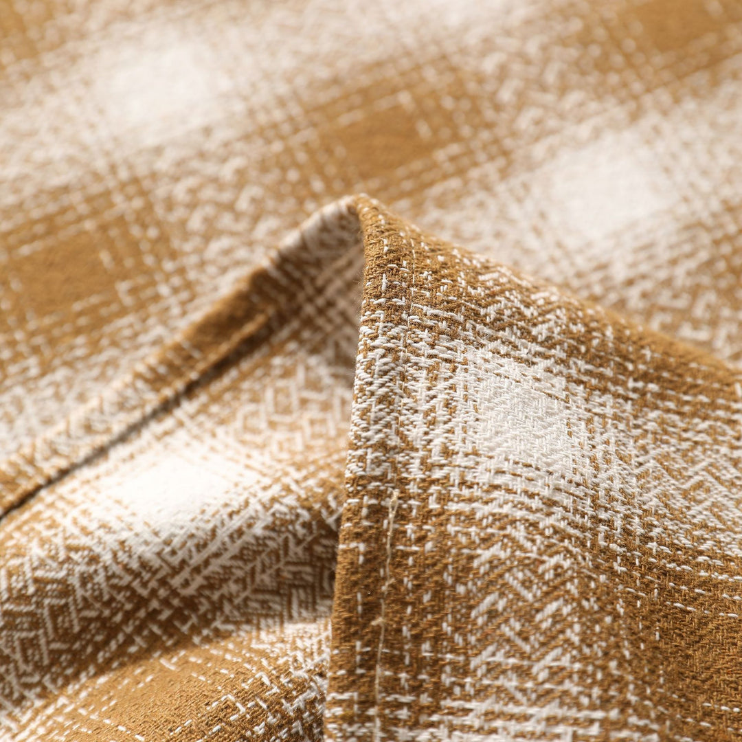 Square tablecloth made of cotton blend fabric with checkered weave pattern and pom-pom corners