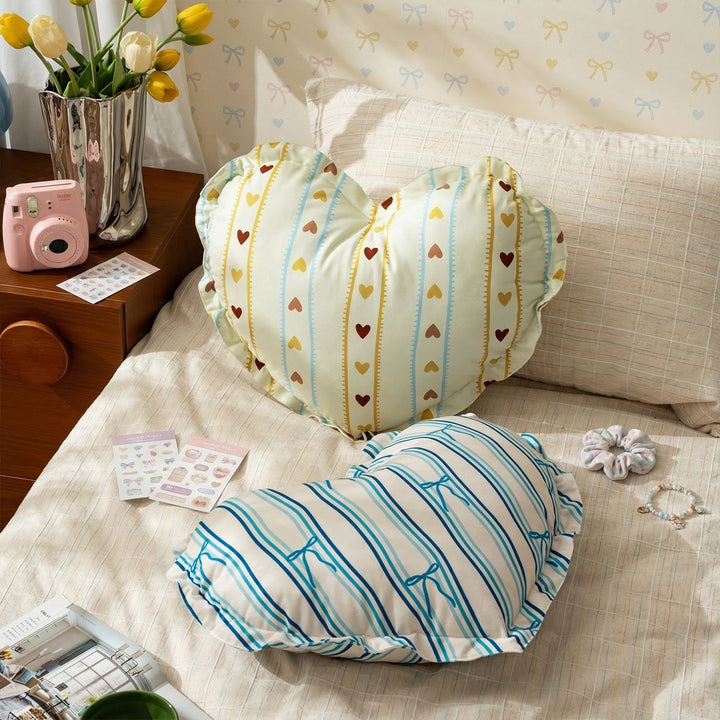 Heart-shaped decorative pillow with ruffled edge and heart pattern