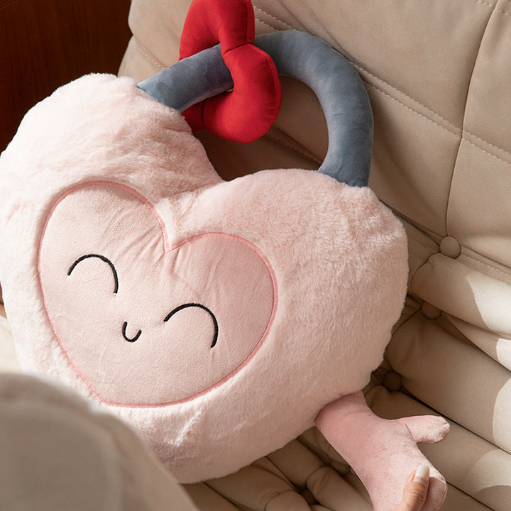 Heart-shaped cuddle castle cushion with attached key and friendly face