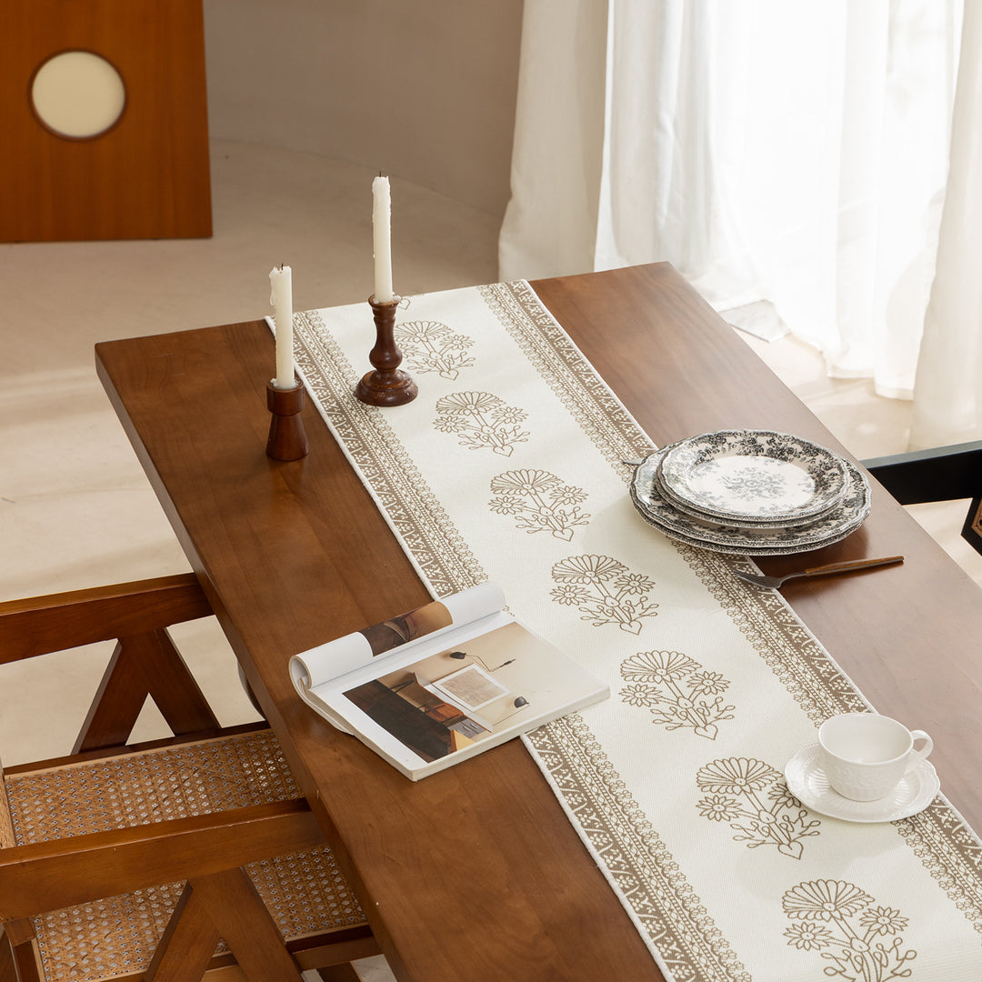 Woven decorative table runner with floral medallion borders and fringes
