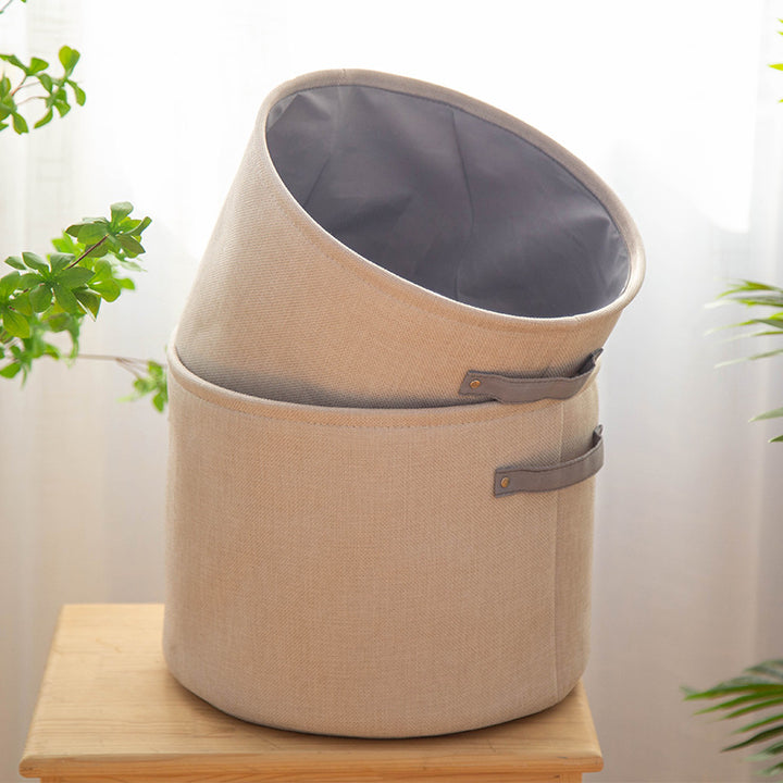 Organizer basket with practical handle and water-repellent inner coating