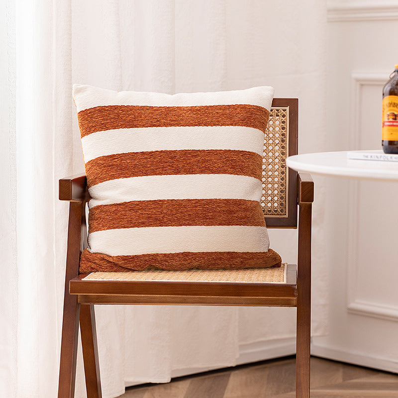 Woven cushion cover with graphic ethnic pattern and contrasting borders