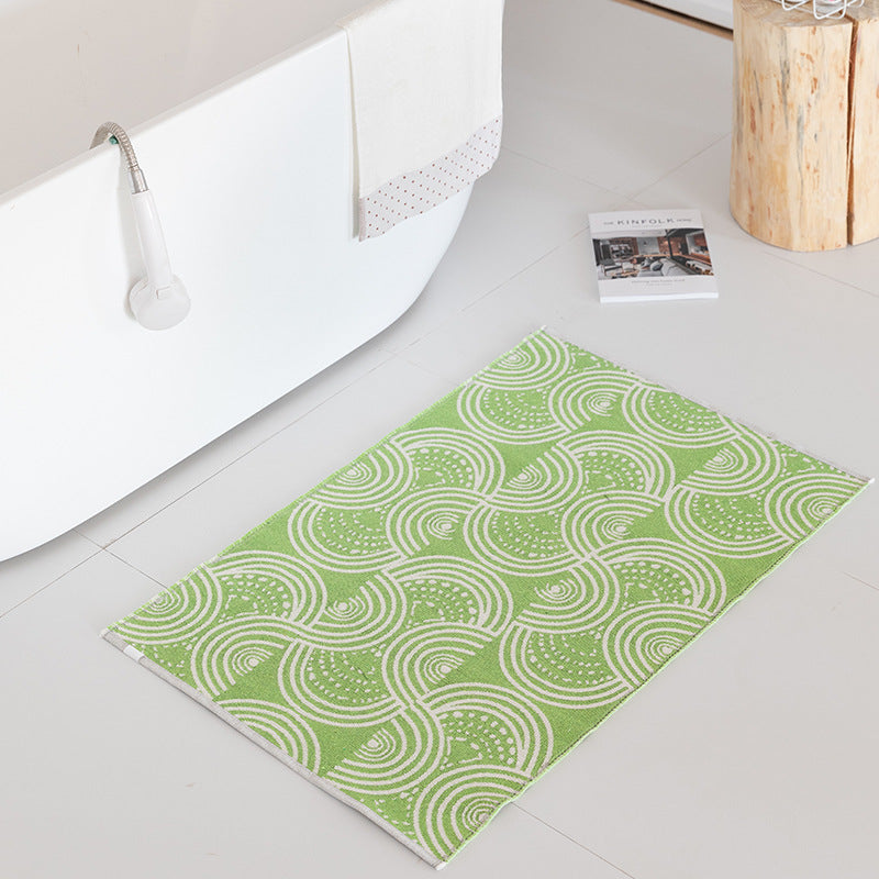 Flat-woven bath mat with abstract geometric pattern