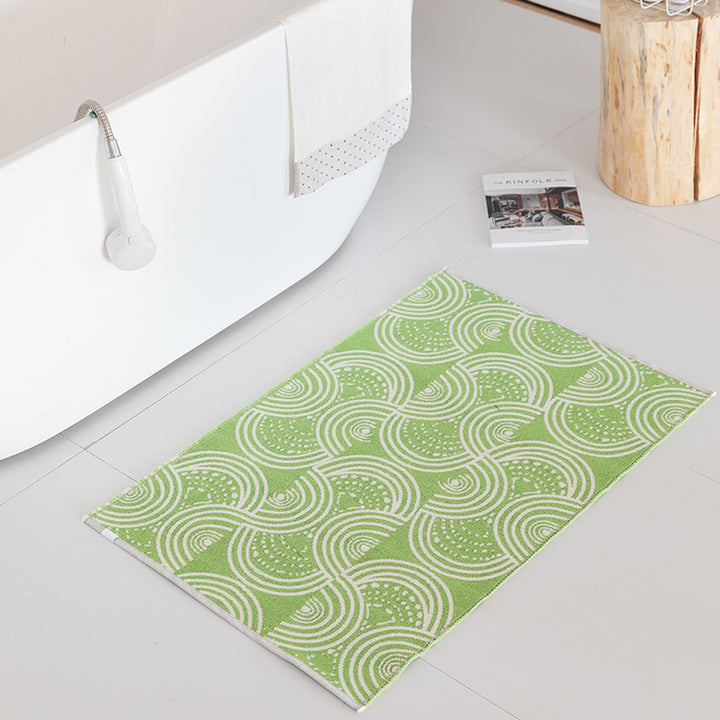Flat-woven bath mat with abstract geometric pattern