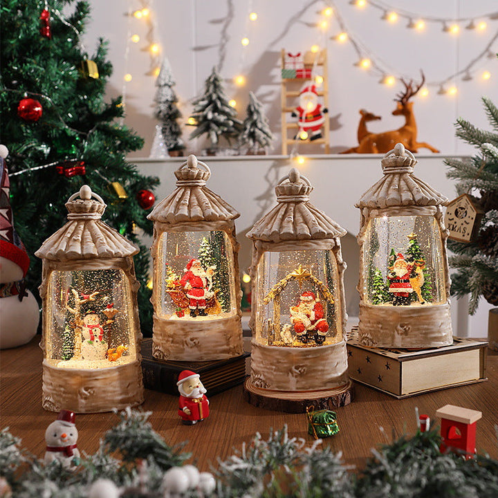 Illuminated Christmas lantern with snow scenes