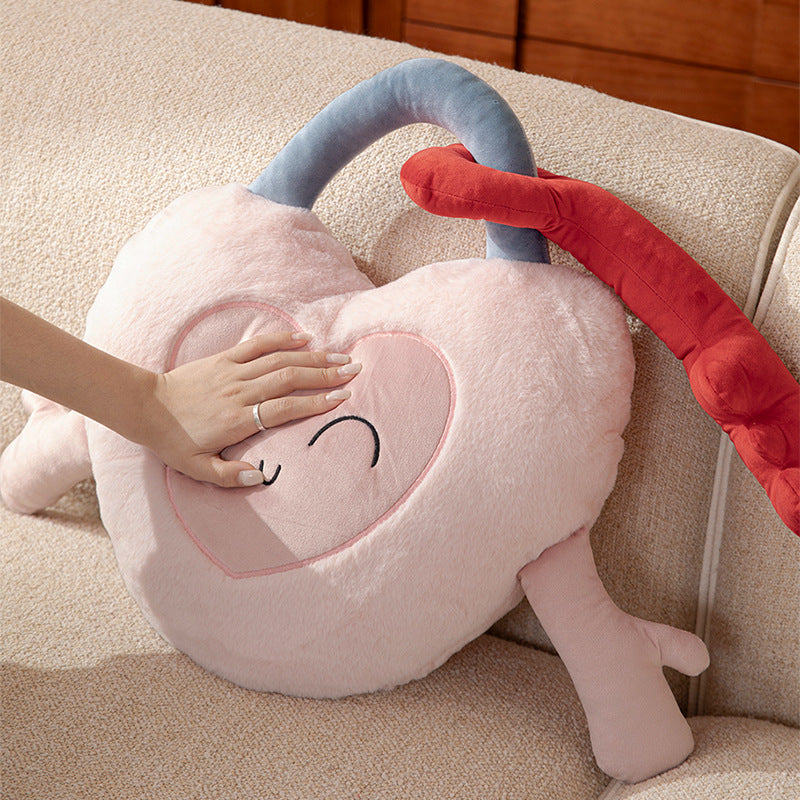 Heart-shaped cuddle castle cushion with attached key and friendly face