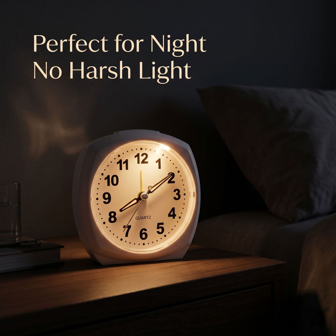 Analog alarm clock with night light and snooze function