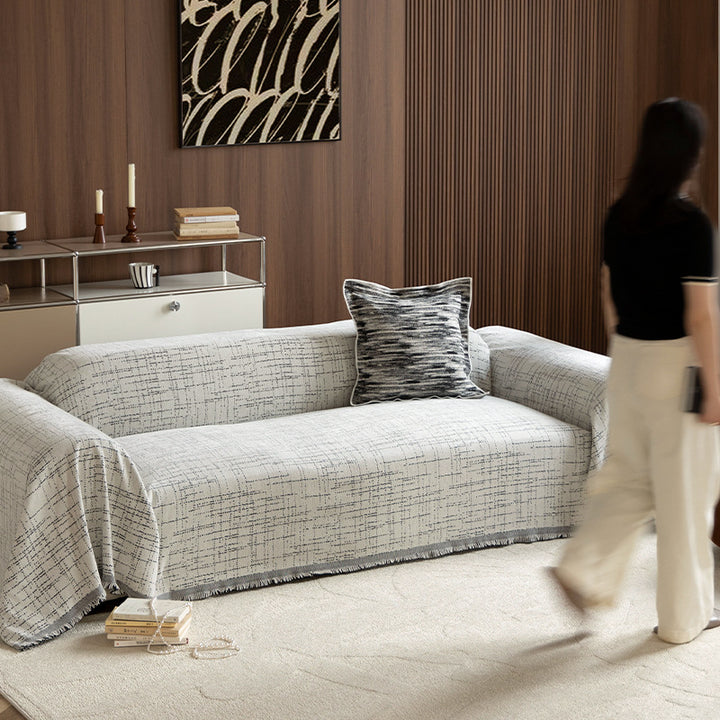 Universal sofa throw made of woven cotton blend with fringes and gentle upholstery cover