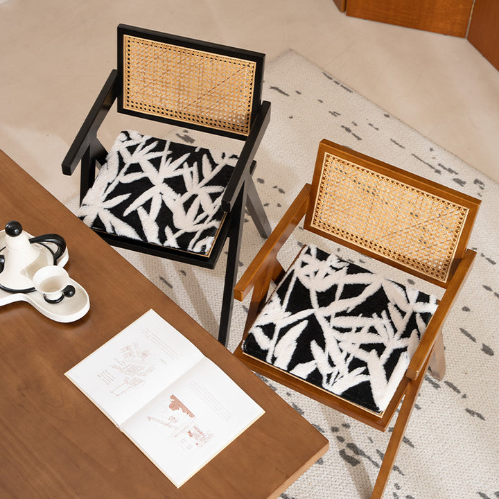 Padded seat cushion with hand-tufted leaf pattern and fastening ties