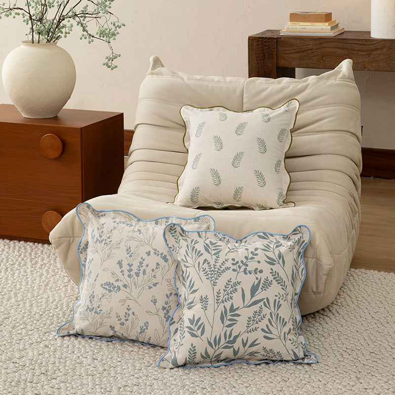 Decorative square decorative pillow with floral print, curved edge and removable cover