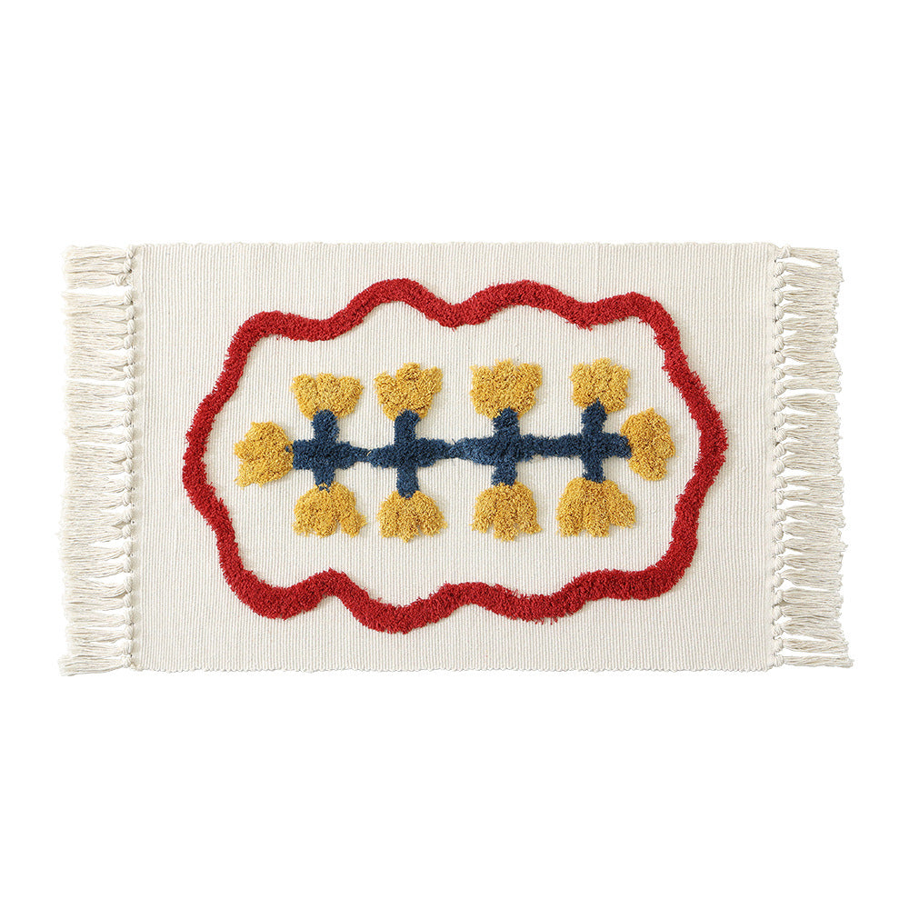 Handwoven cotton bath mat rug with tufted flower appliqué and tassels