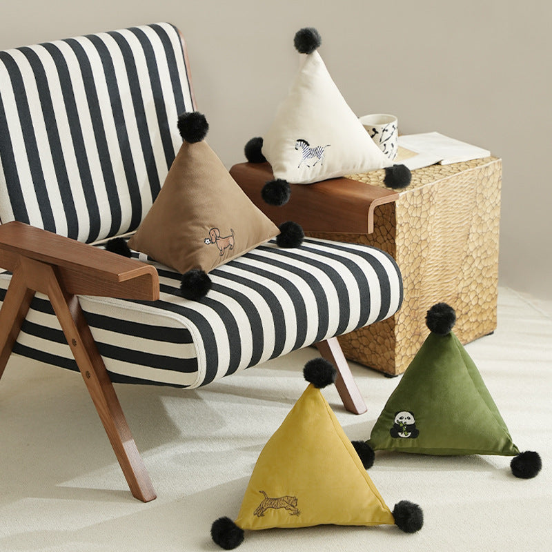 Triangular decorative pillow with zebra embroidery, pompom applications, and soft velvet cover