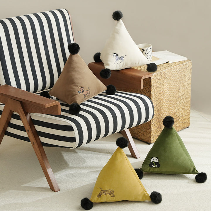 Triangular decorative pillow with zebra embroidery, pompom applications, and soft velvet cover