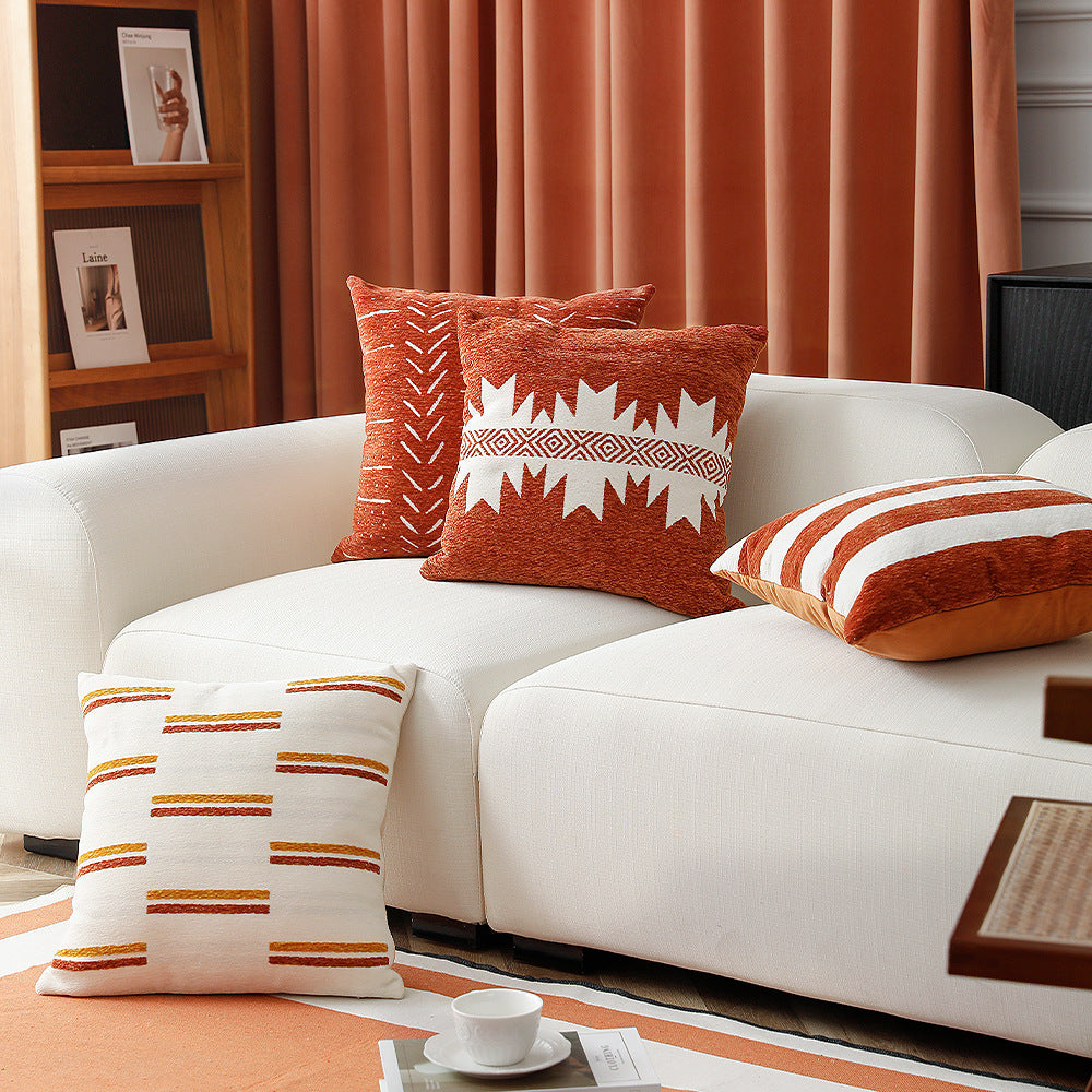 Woven cushion cover with graphic ethnic pattern and contrasting borders