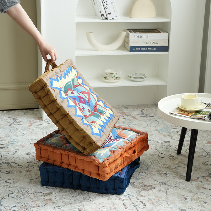 Padded seat and floor cushion with carrying handle and graphic ethno pattern