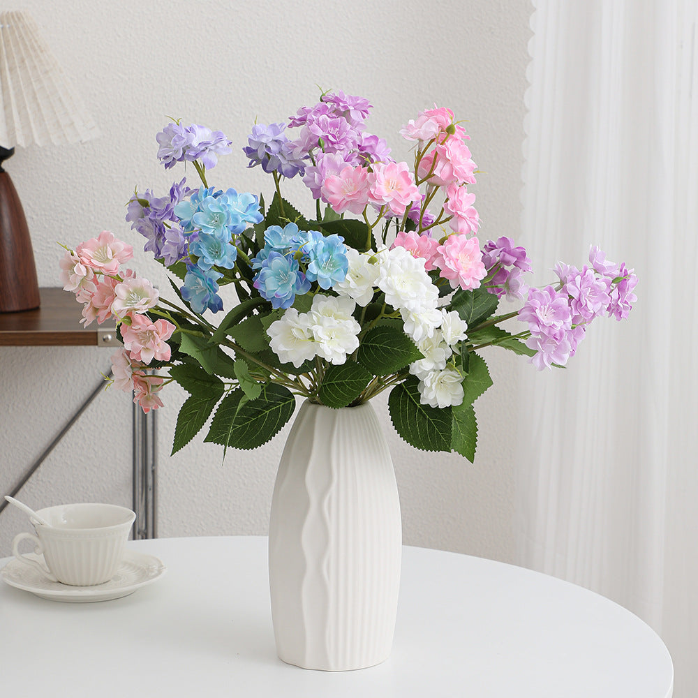 Artificial flower arrangement with delicate white blooms