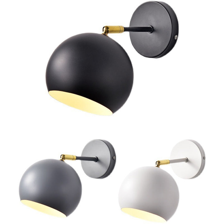 Adjustable matte metal globe wall lamp with brass pivot arm