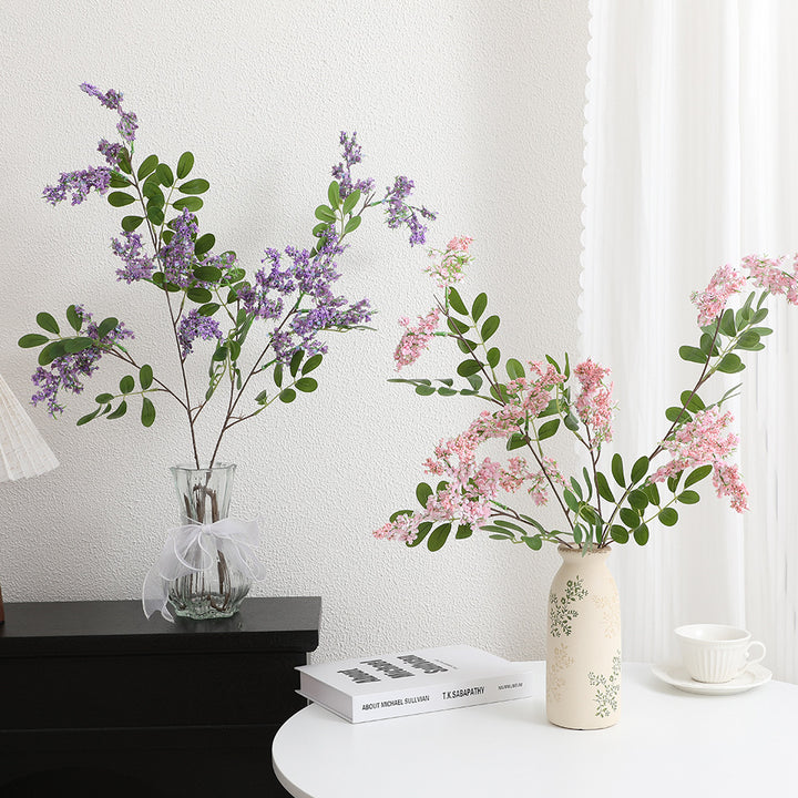 Artificial flower branch with vibrant purple flowers