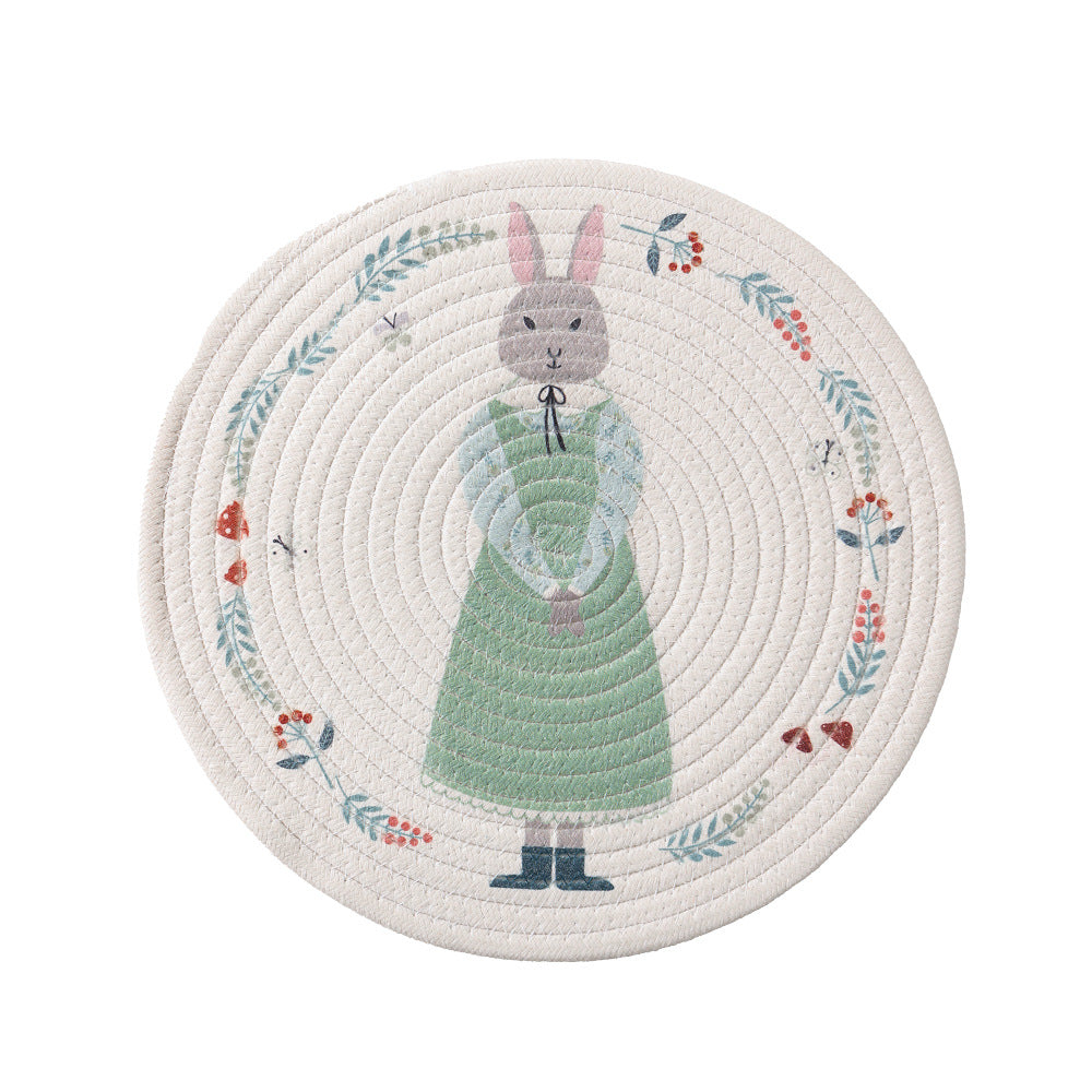 Round placemat made of woven cotton with a cute rhinoceros illustration and floral wreath
