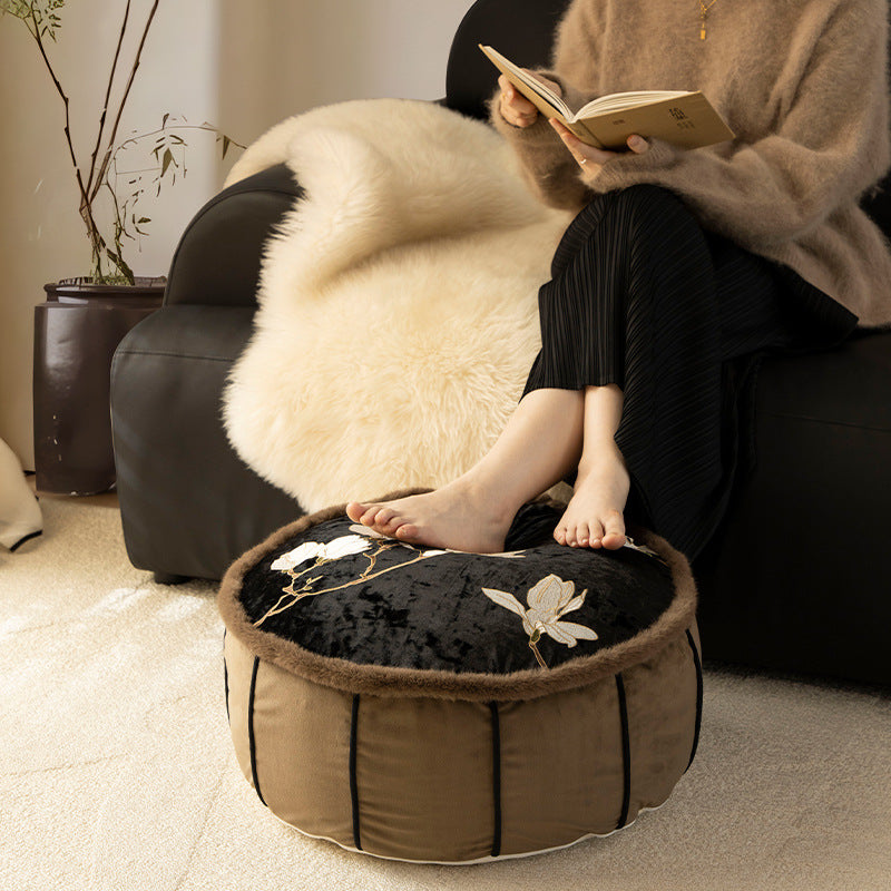 Round upholstered velvet floor cushion pouf with faux fur trim and handle