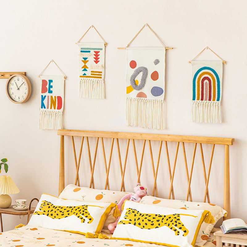 Boho wall hanging made of woven cotton with hand-tufted appliqués and fringes