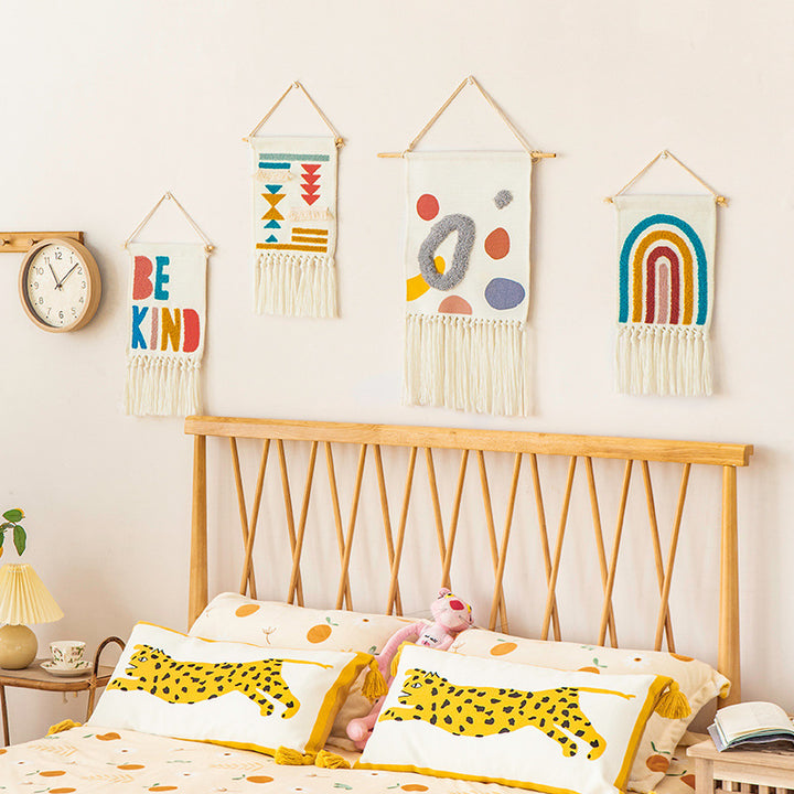 Boho wall hanging made of woven cotton with hand-tufted appliqués and fringes