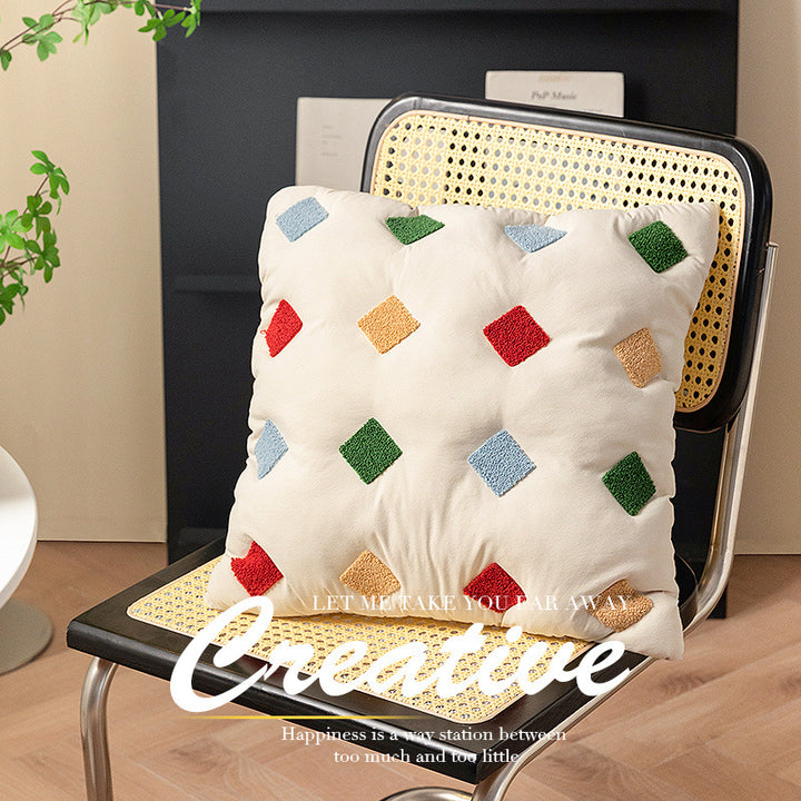 Filled decorative cushion with colorful tuft diamonds and padded structure