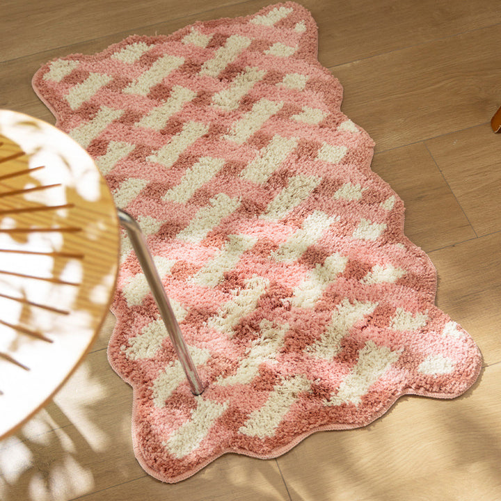 Tufted bathroom runner with wavy hem and relief-style braided pattern