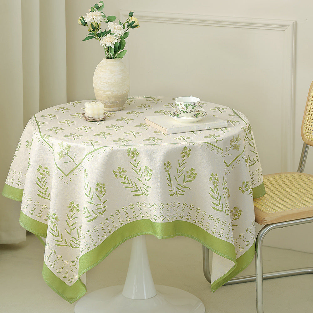 Cotton blend tablecloth with woven floral border decor and green hem
