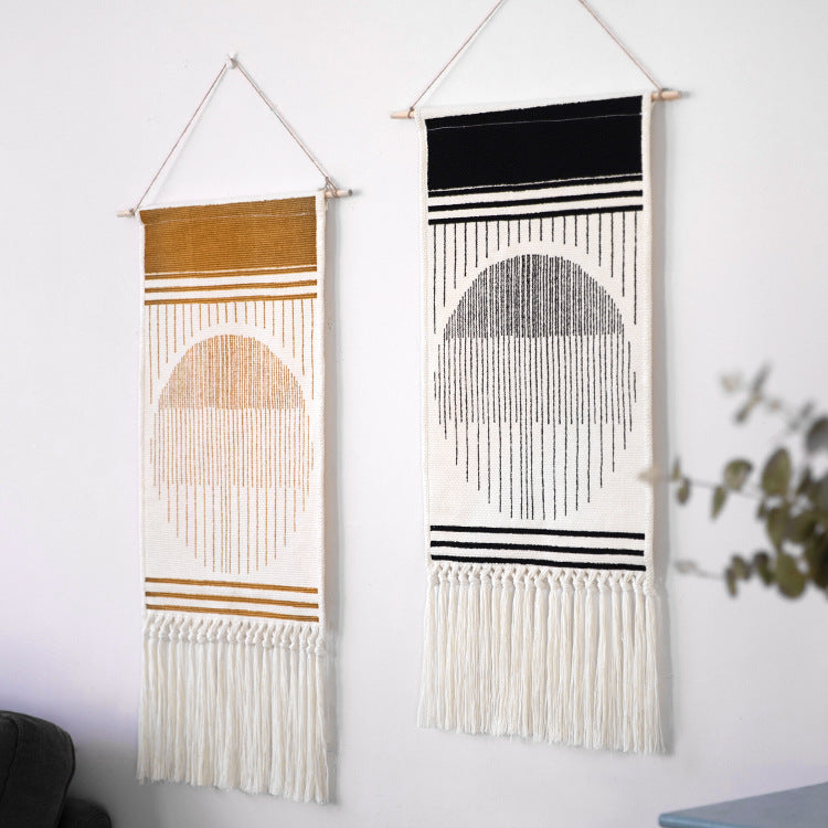 Woven Boho wall tapestry in Ethno design with long fringes and wood stick