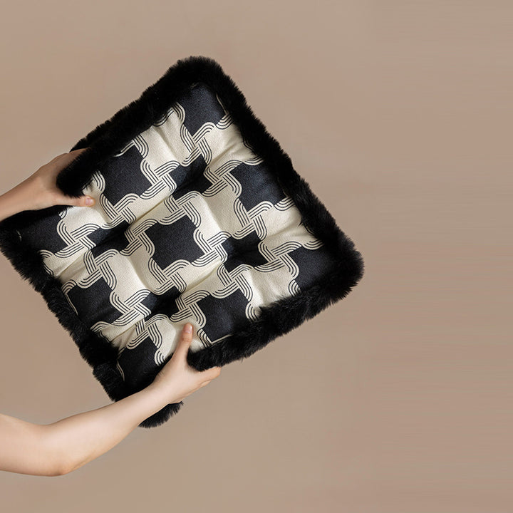 Padded seat cushion with fastening straps, quilted tufting surface and faux fur trim