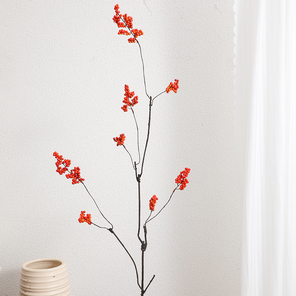 Decorative artificial flower branch with glowing red berries