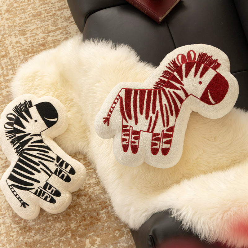 Shaped children's room decorative pillow made of teddy fleece with embroidered zebra motif and contoured silhouette