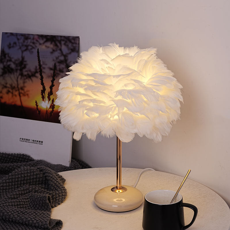 Feather shade table lamp with ceramic base and polished metal rod