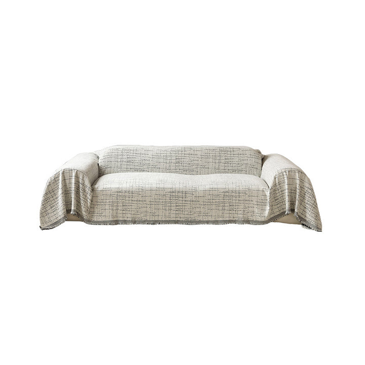 Universal sofa throw made of woven cotton blend with fringes and gentle upholstery cover