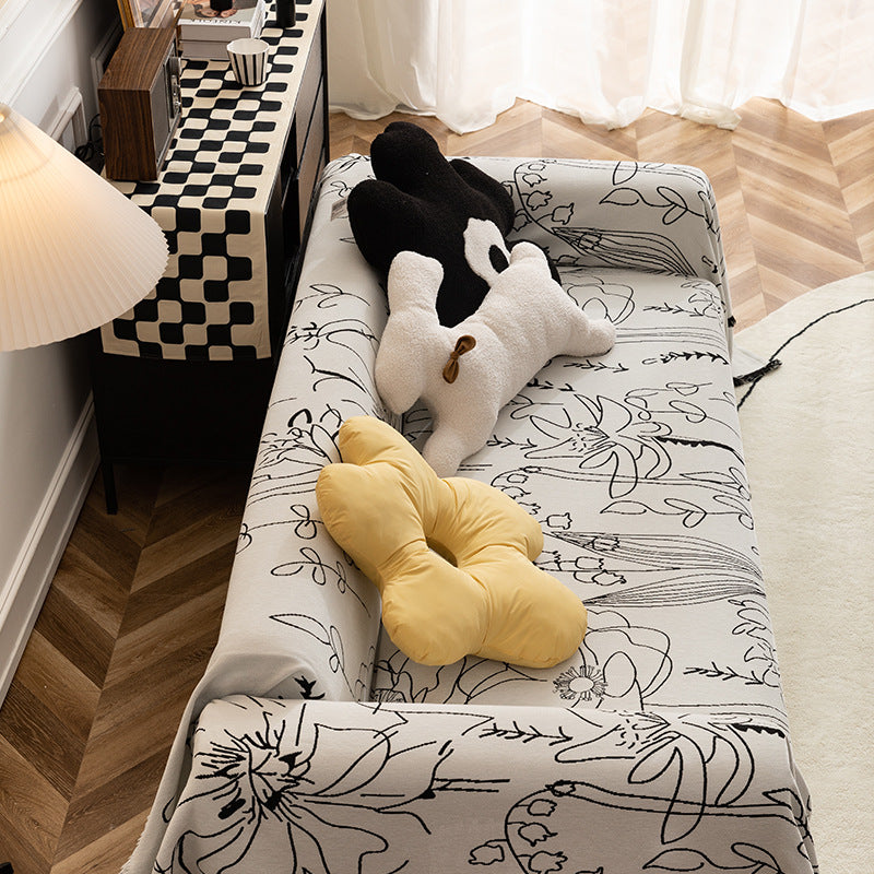 Fine woven sofa cover and furniture throw with floral line drawing and decorative fringed edge