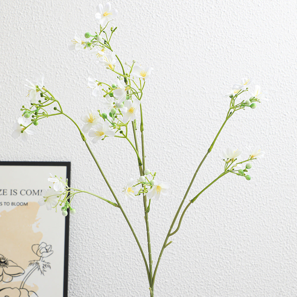 Artificial flower branch with delicate blue flowers and green berries
