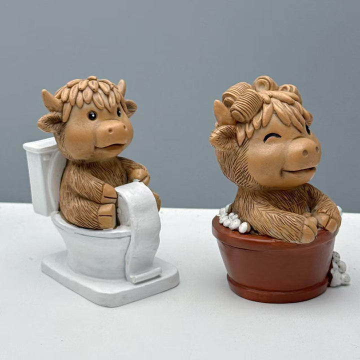 Funny decorative figure of a Highland cow on toilet