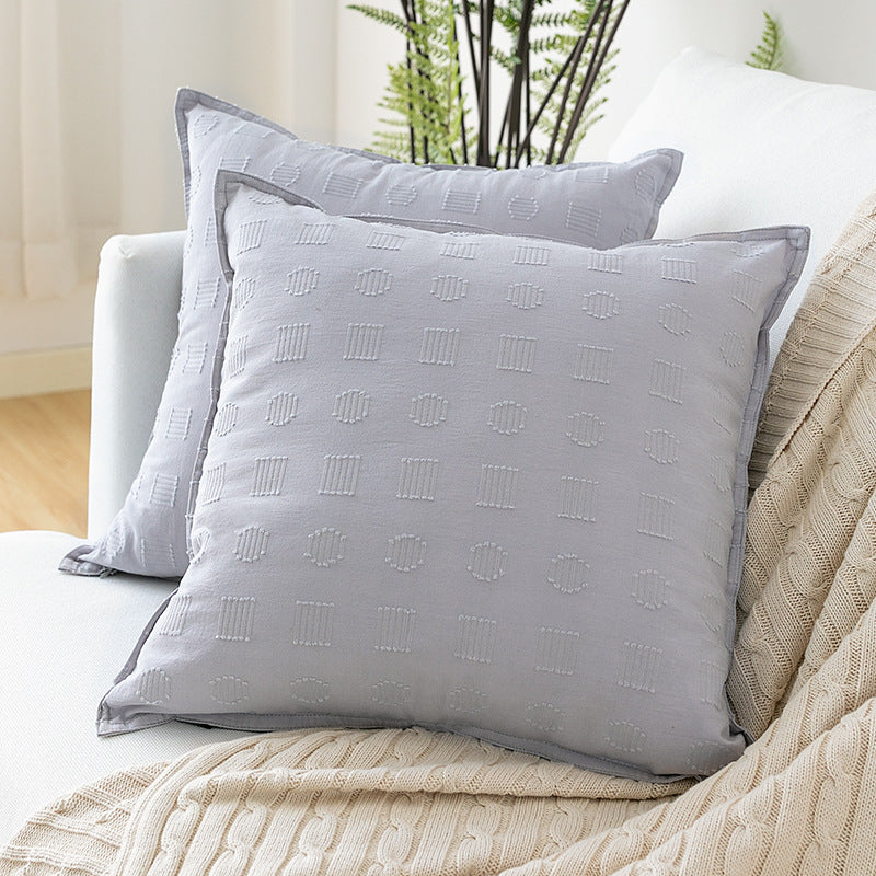 Square decorative cushion cover with subtle tufted geometric relief and piping