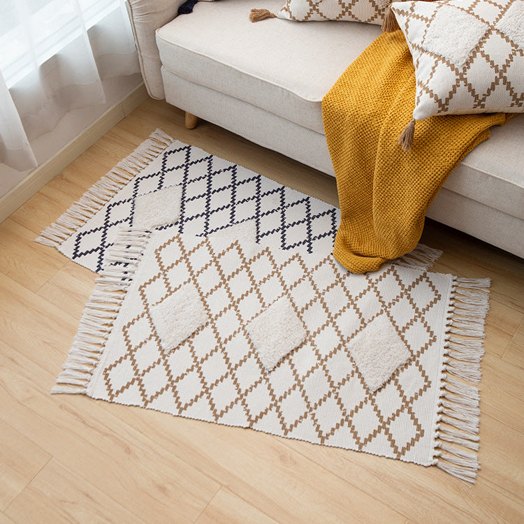 Flat Boho runner rug made of cotton blend fabric with geometric hexagon tufting and decorative fringed edge.