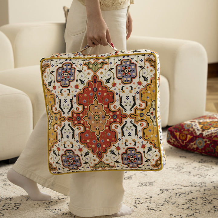Square decorative cushion with oriental medallion print, piping and carrying handle